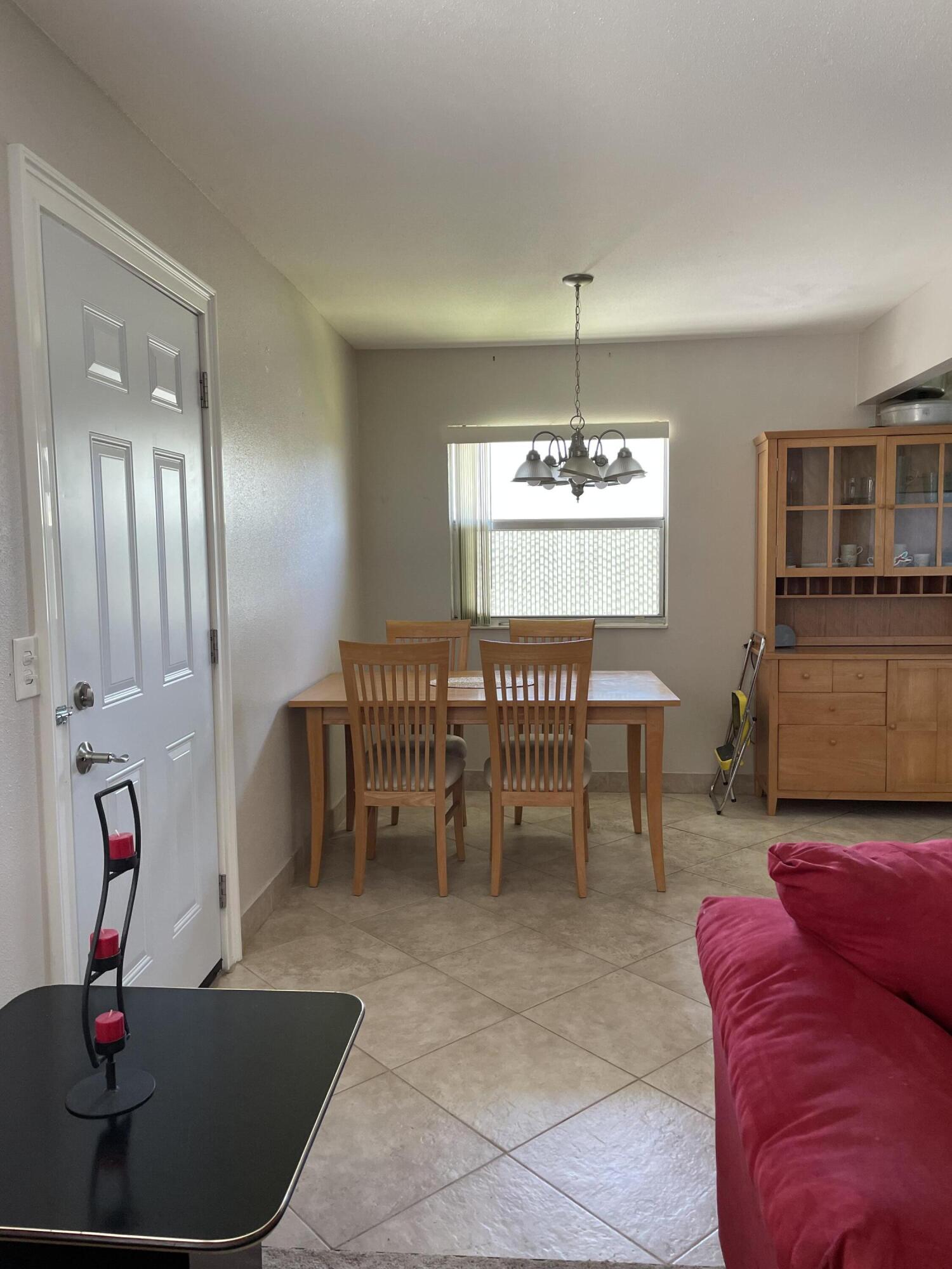 237 Monaco Way Delray Beach, FL 33446 - Photo 3 of 10 a living room with furniture and a chandelier