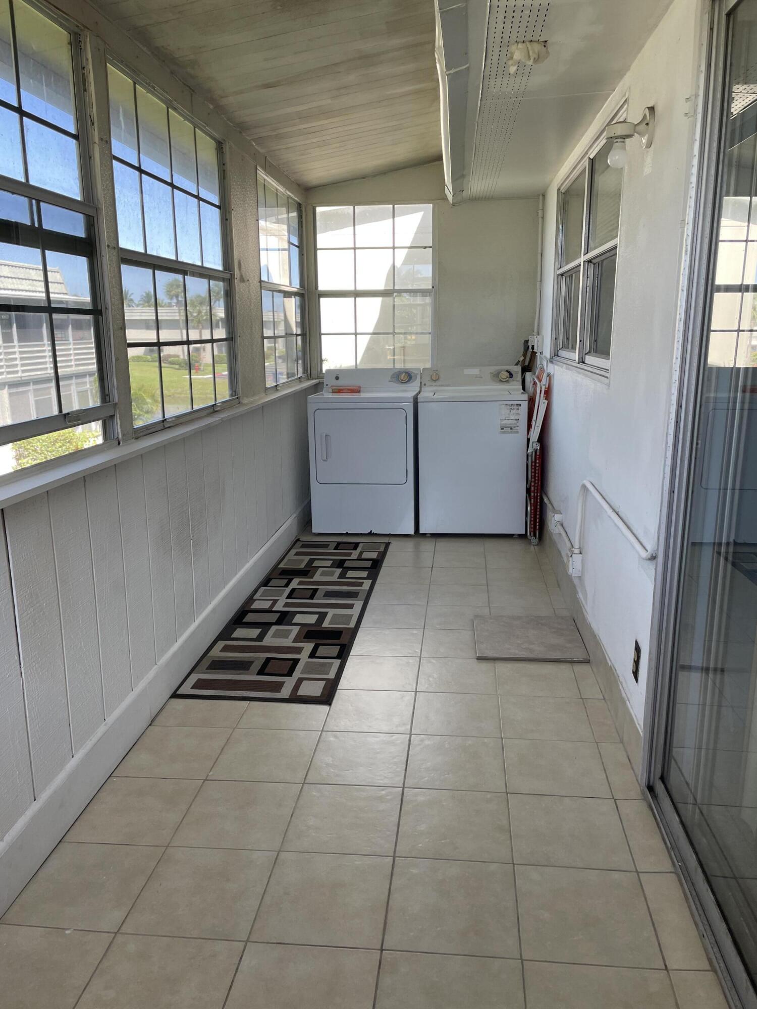 237 Monaco Way Delray Beach, FL 33446 - Photo 7 of 10 a kitchen with a stove window and cabinets
