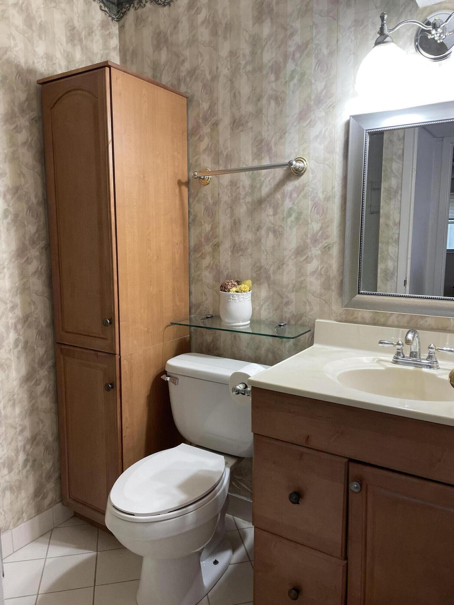 237 Monaco Way Delray Beach, FL 33446 - Photo 9 of 10 a bathroom with a sink a toilet and shower