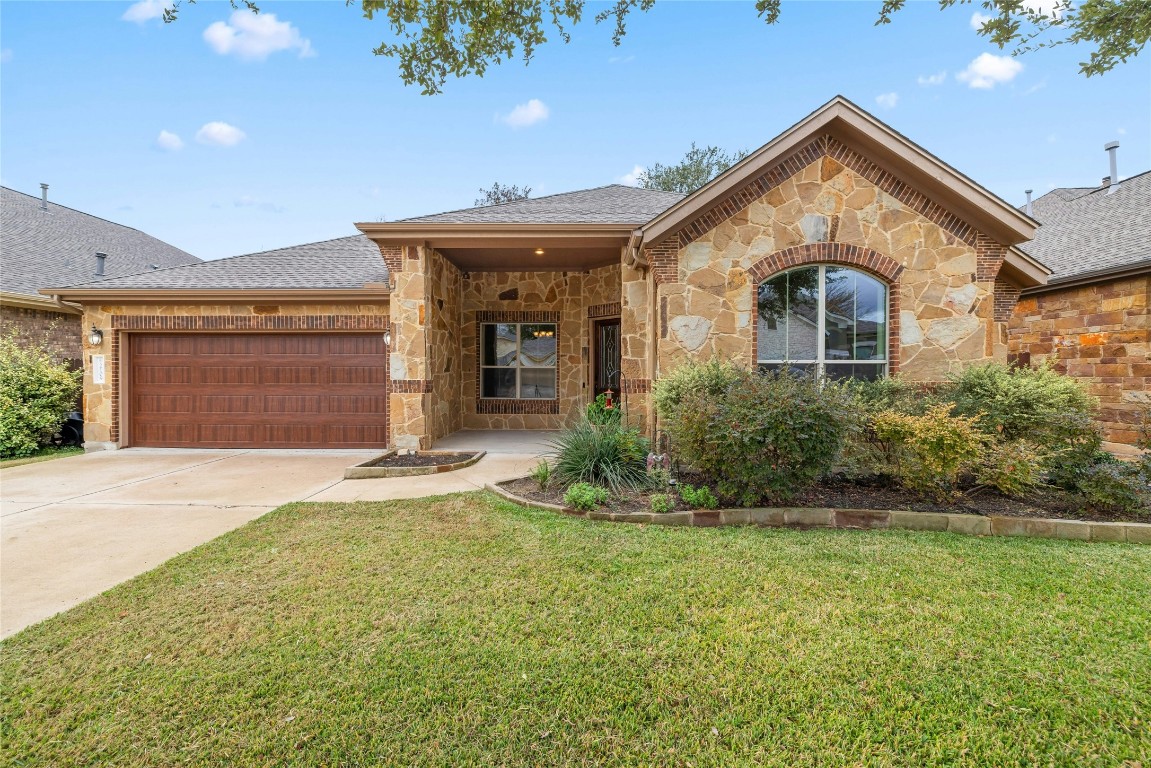a front view of a house with a yard and garage