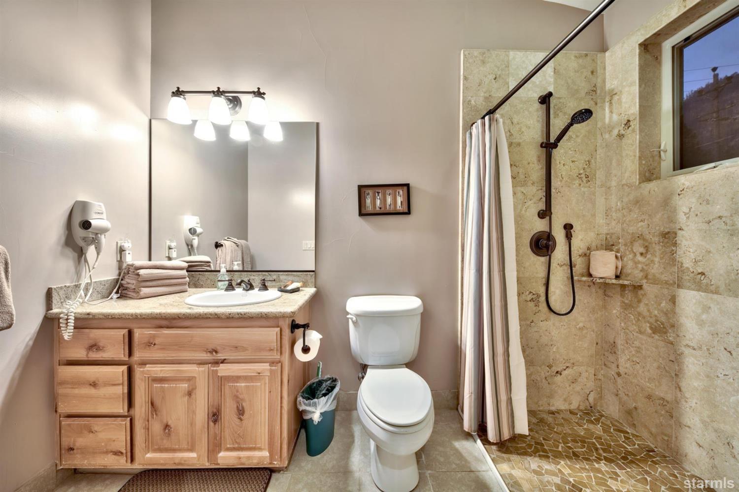 3639 Saddle Road South Lake Tahoe, CA 96150 - Photo 19 of 25 a bathroom with a granite countertop sink toilet and shower