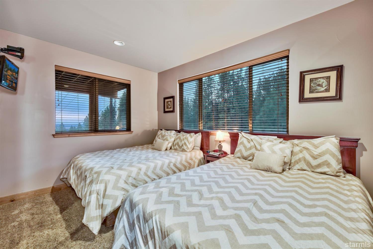 3639 Saddle Road South Lake Tahoe, CA 96150 - Photo 22 of 25 a bedroom with a large bed and a large window