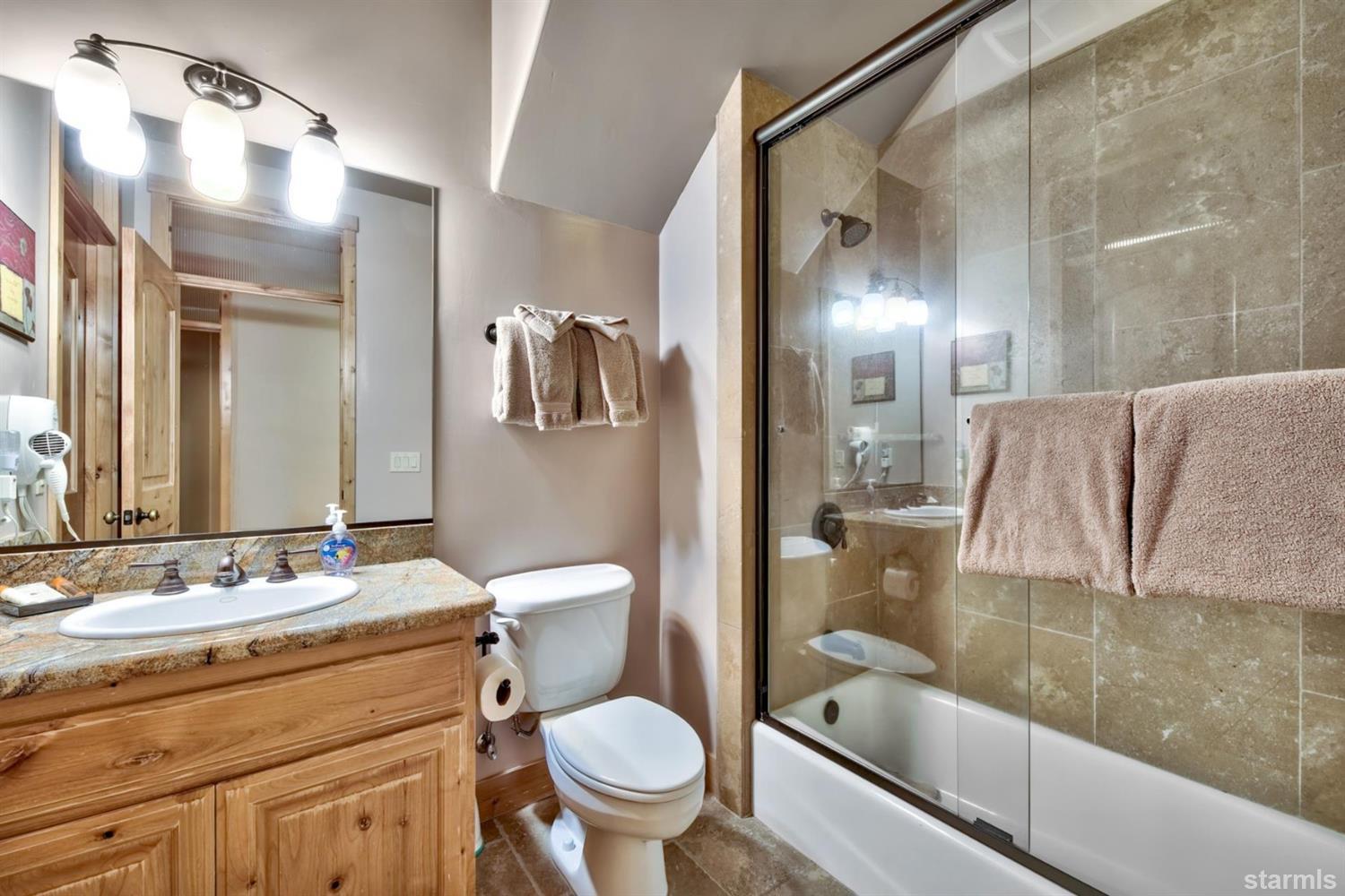3639 Saddle Road South Lake Tahoe, CA 96150 - Photo 25 of 25 a bathroom with a granite countertop sink toilet and shower