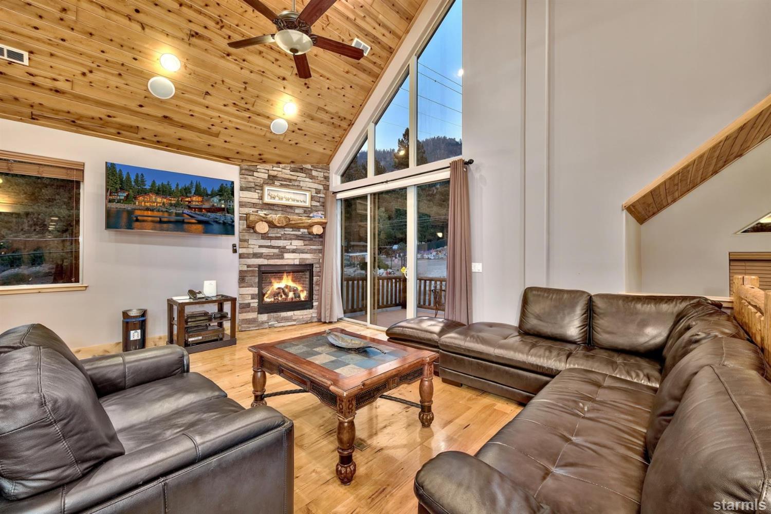 3639 Saddle Road South Lake Tahoe, CA 96150 - Photo 9 of 25 a living room with furniture a flat screen tv and a large window