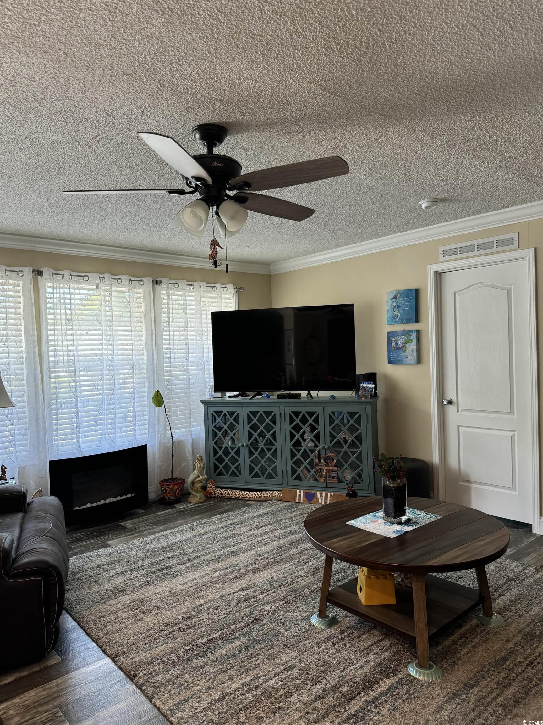 1651 Perry Circle Myrtle Beach, SC 29577 - Photo 9 of 32 Living area with crown molding, dark wood finished floors, a textured ceiling, and ceiling fan
