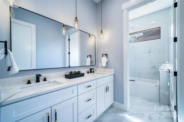 a bathroom with a double vanity sink and mirror