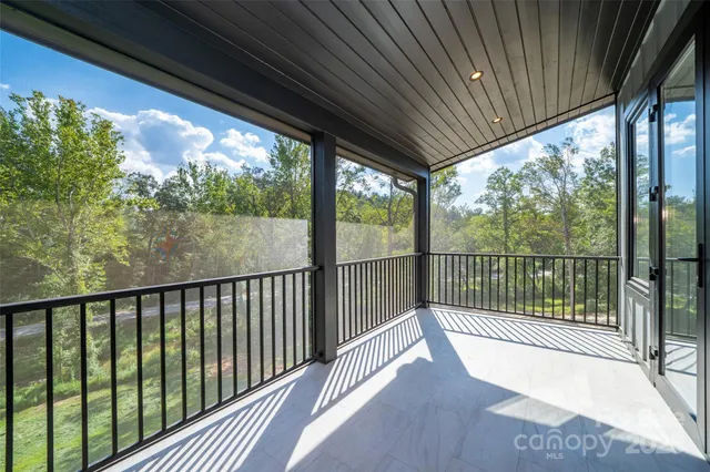 a living room with furniture a chandelier and a fireplace