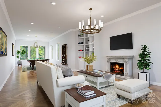 a living room with furniture and a chandelier