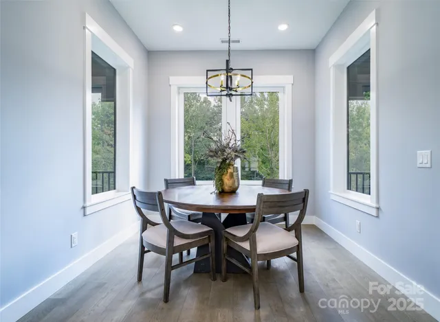 a bedroom with a large bed and wooden floor