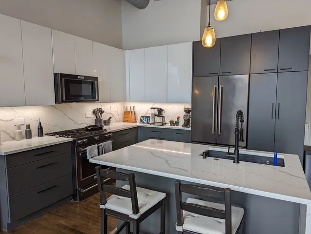 a kitchen with a sink cabinets and stainless steel appliances