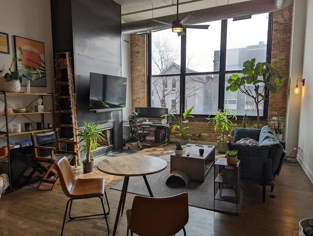 a living room with furniture a flat screen tv and a large window
