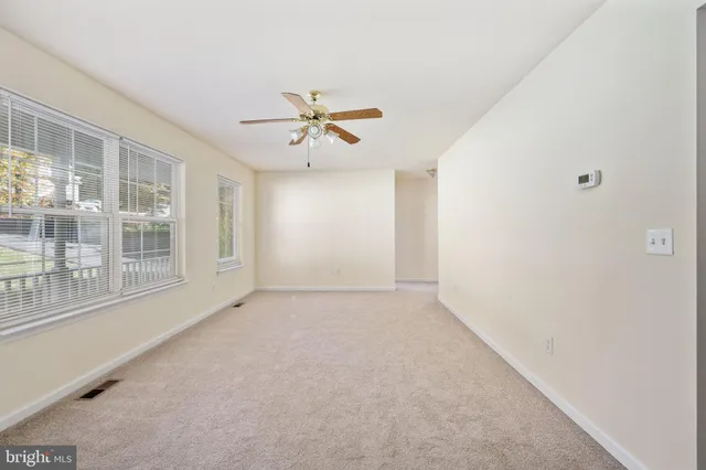 a kitchen with stainless steel appliances granite countertop a refrigerator a sink dishwasher and wooden cabinets with wooden floor