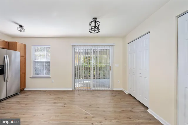 an empty room with wooden floor and a window