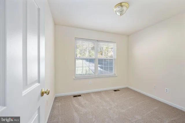 a bathroom with a sink and mirror with toilet