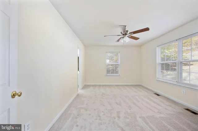 a view of a patio with table and chairs under an umbrella