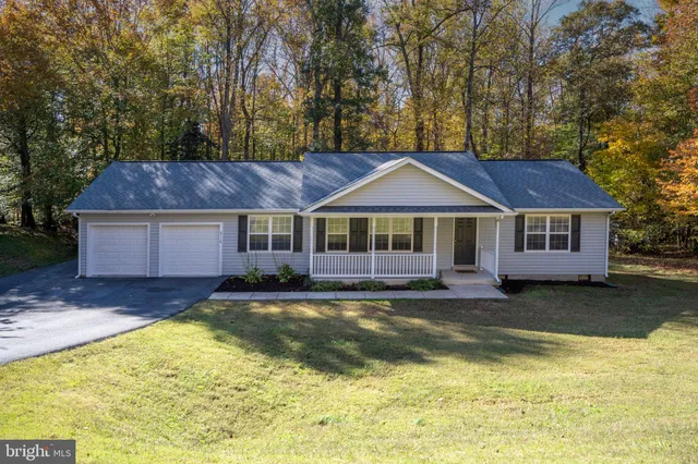 a view of a house with a yard patio and a swimming pool