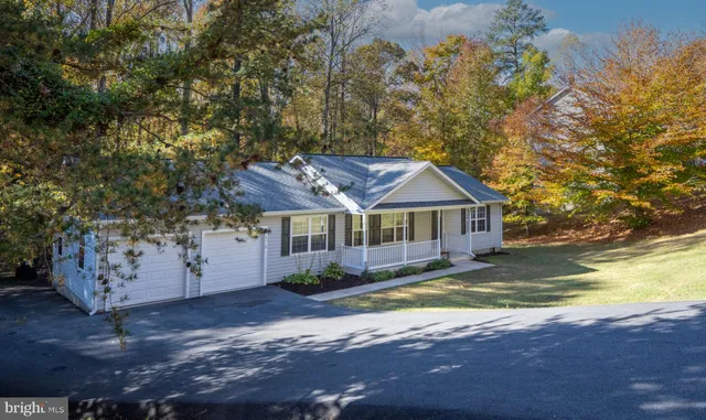 a aerial view of a house with swimming pool next to a yard