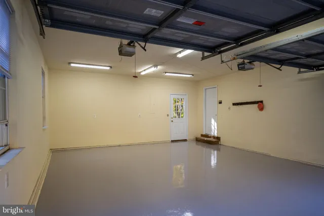 a view of an empty room with cabinet and a window