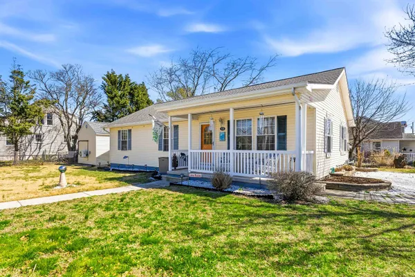 a view of a house with a swimming pool and sitting area