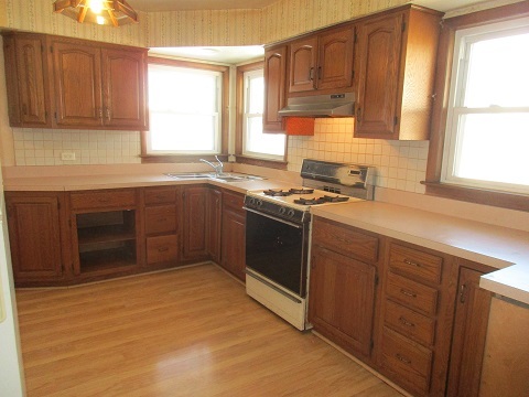 332 North Wolf Road Hillside, IL 60162 - Photo 6 of 16 a kitchen with stainless steel appliances granite countertop a sink stove and cabinets