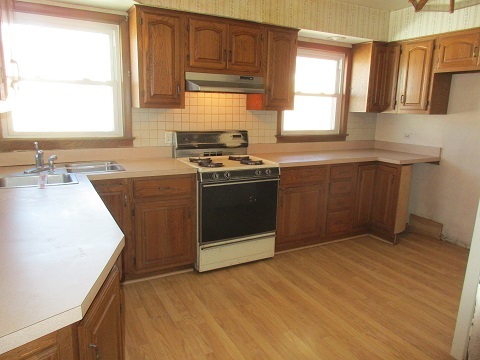 332 North Wolf Road Hillside, IL 60162 - Photo 7 of 16 a kitchen with a sink stove top oven and cabinets