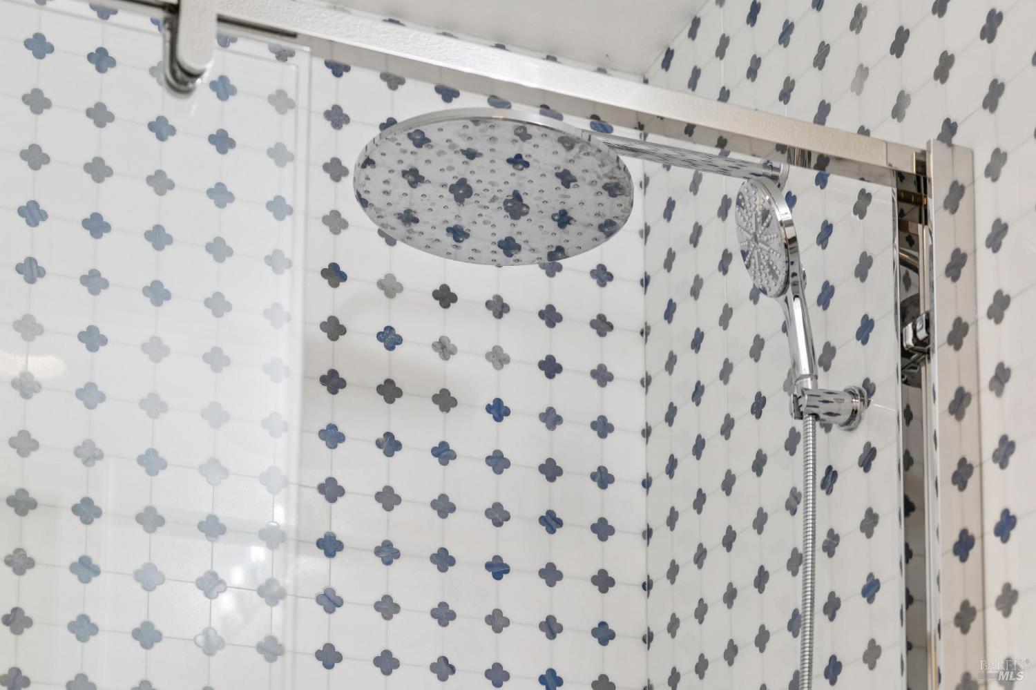 1045 Susan Way Novato, CA 94947 - Photo 50 of 62 Tastefully crafted tilework in the tub shower enclosure, complemented by a rain shower and handheld showerheads.