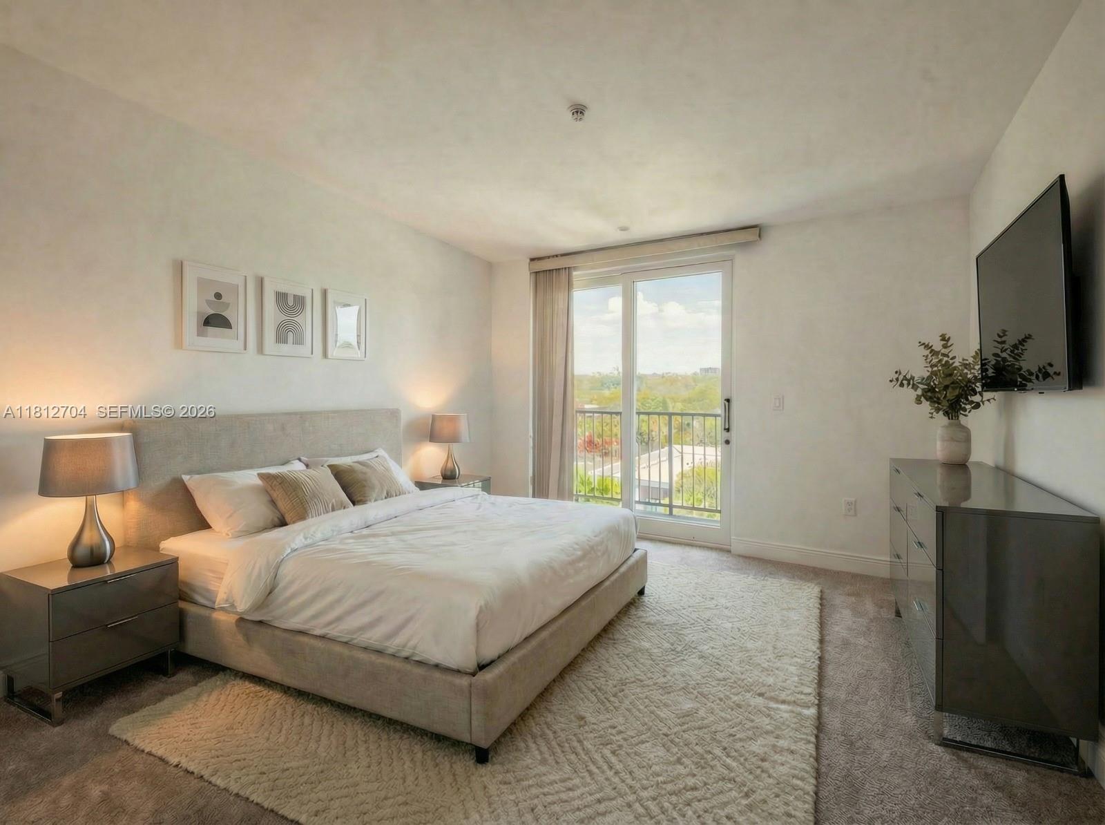 2701 Southwest 3rd Avenue, Unit 503 Miami, FL 33129 - Photo 3 of 16 a bedroom with a bed flat screen tv and a large window