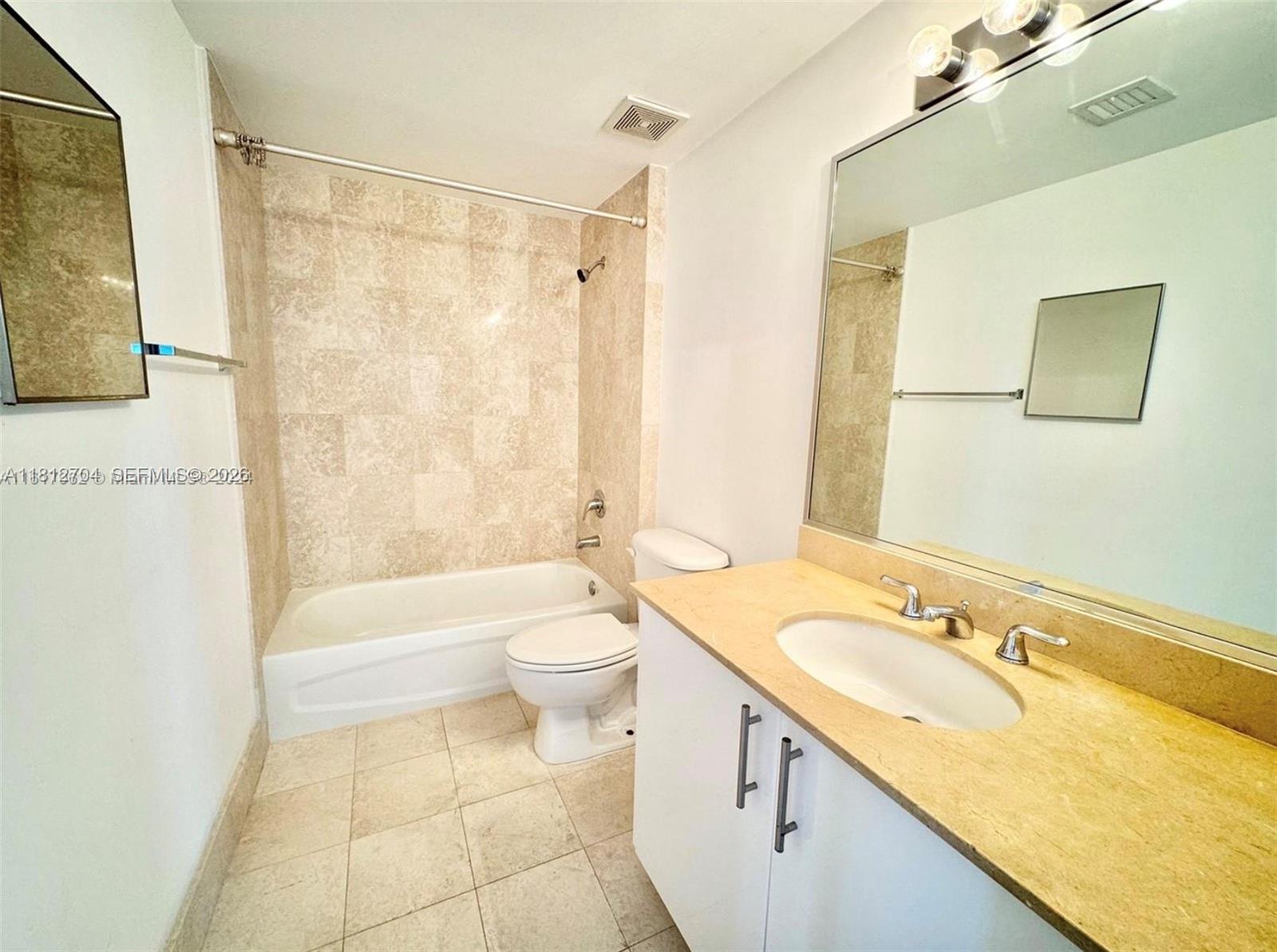 2701 Southwest 3rd Avenue, Unit 503 Miami, FL 33129 - Photo 10 of 16 a bathroom with a granite countertop sink toilet and shower