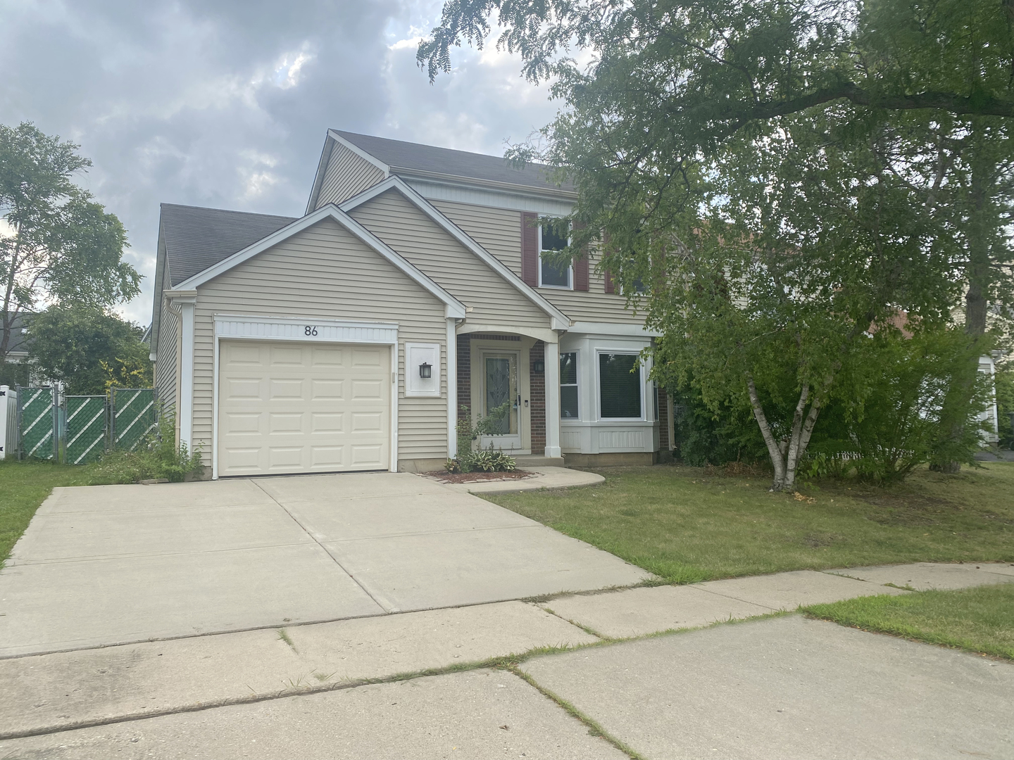 86 Bradford Lane Mundelein, IL 60060 - Photo 1 of 21 a front view of house with yard and trees