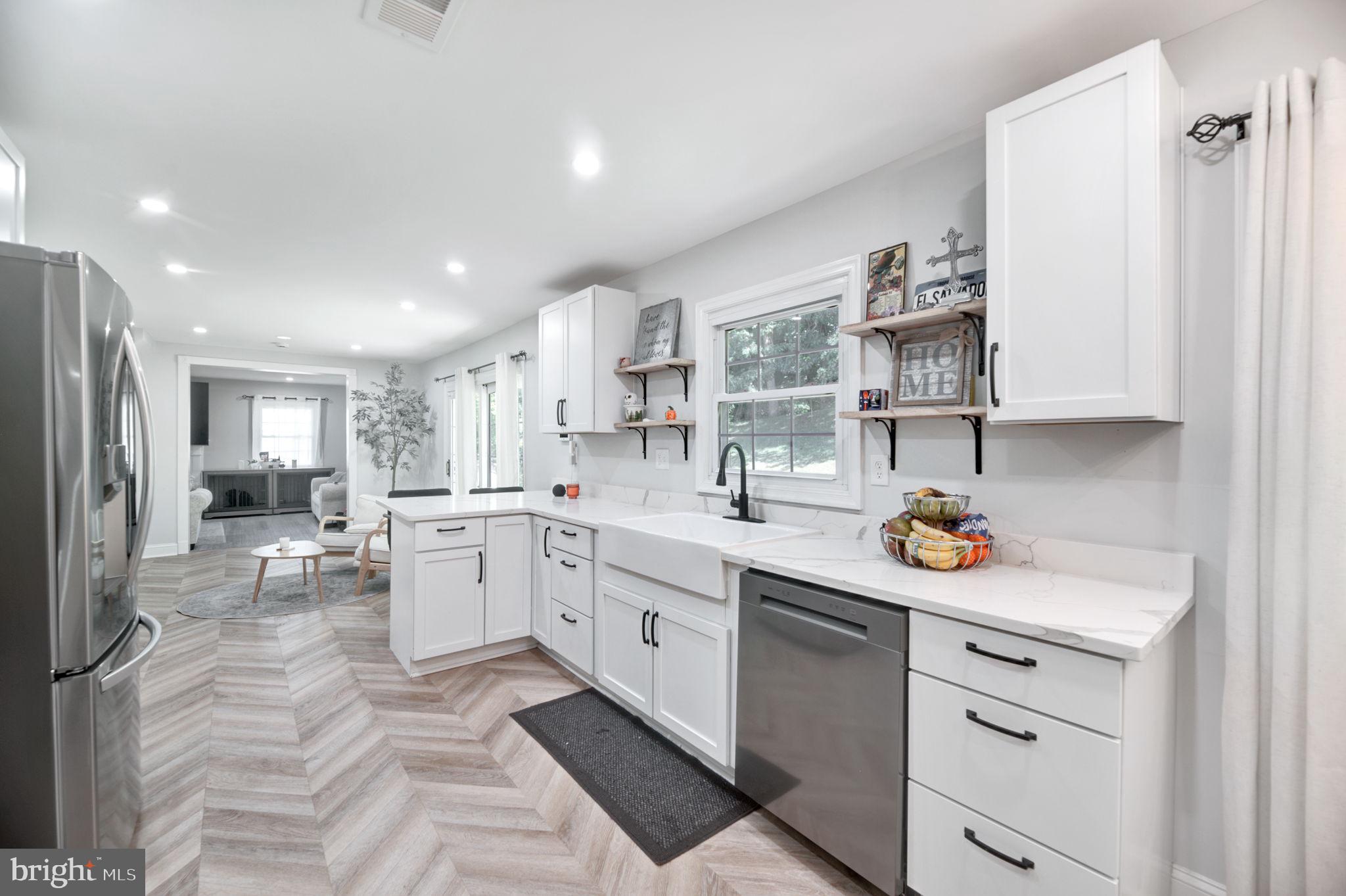 8812 Churchfield Lane Laurel, MD 20708 - Photo 2 of 31 a kitchen with a sink cabinets and window