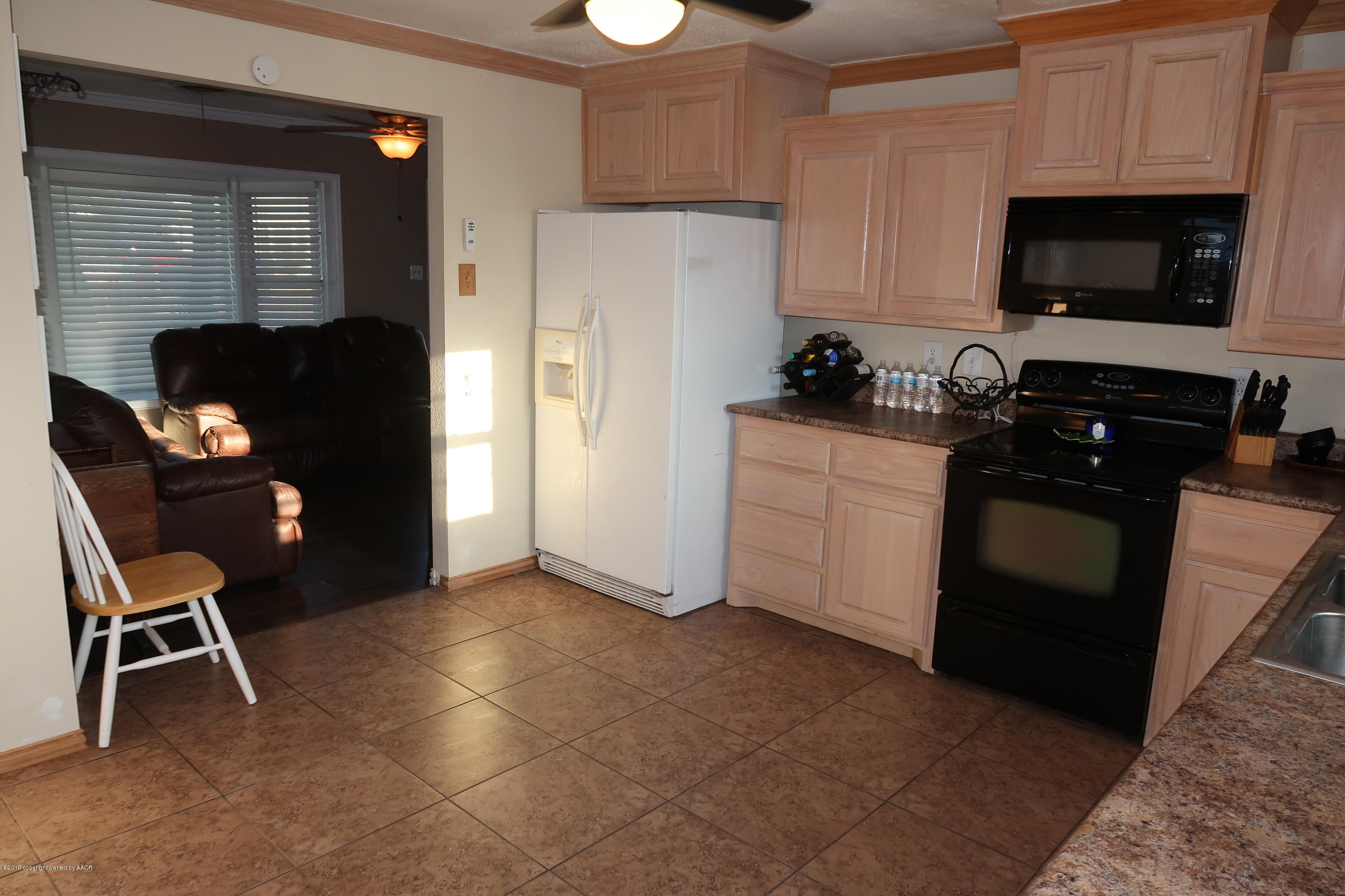 4628 South Bonham Street Amarillo, TX 79110 - Photo 8 of 22 a kitchen with stainless steel appliances granite countertop a refrigerator and a stove top oven
