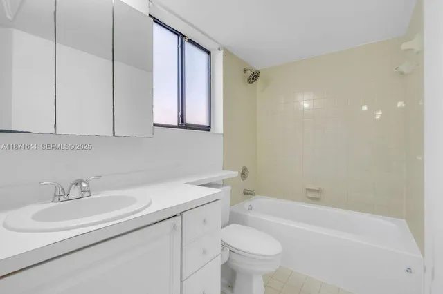 a bathroom with a sink a toilet and bathtub