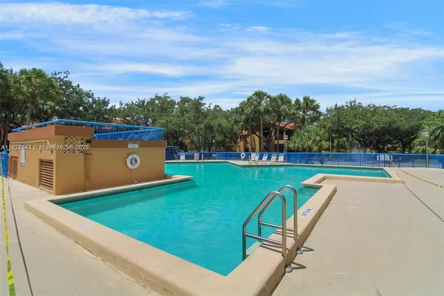 a view of a swimming pool with a yard