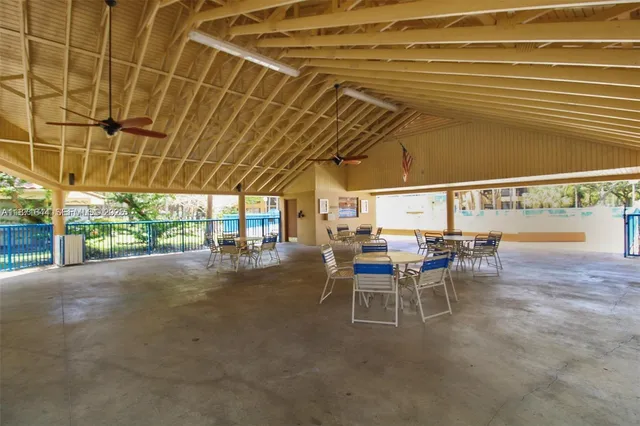 a view of a patio with table and chairs
