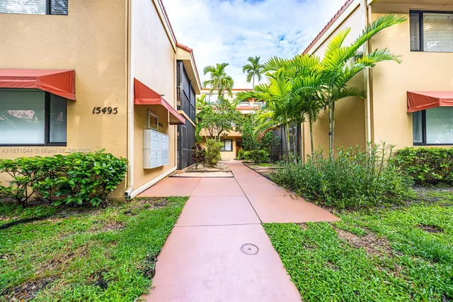 a view of a back yard with flower plants
