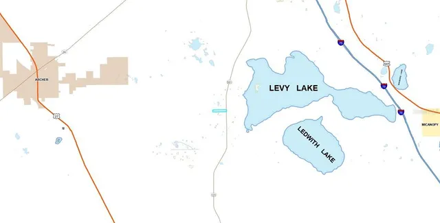 an aerial view of residential houses with outdoor space and trees