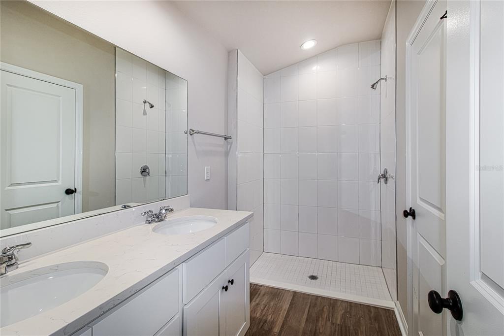 46 Ash Road Ocala, FL 34472 - Photo 11 of 20 a bathroom with a shower sink vanity and mirror