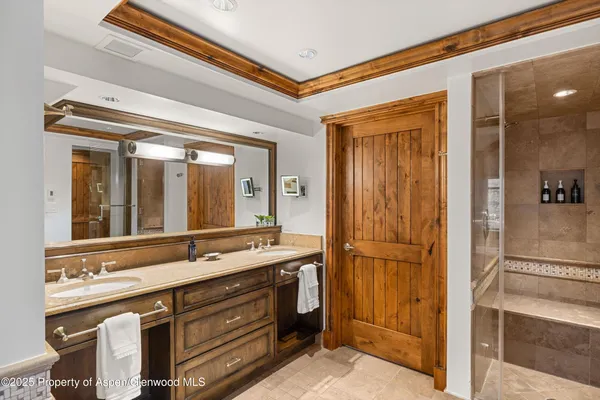 a bathroom with a double vanity sink and mirror