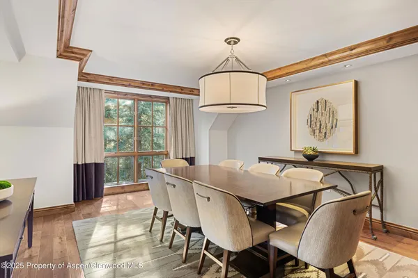 a view of a dining room with furniture window and wooden floor