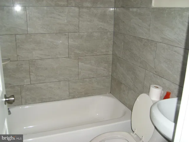 a bathroom with a bathtub and shower