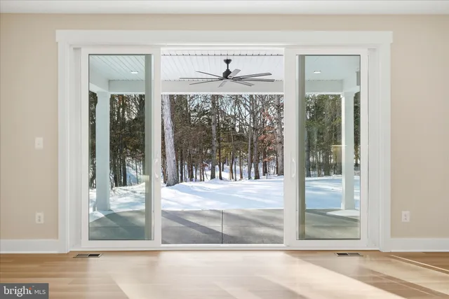 a view of a room with a floor to ceiling window and front door