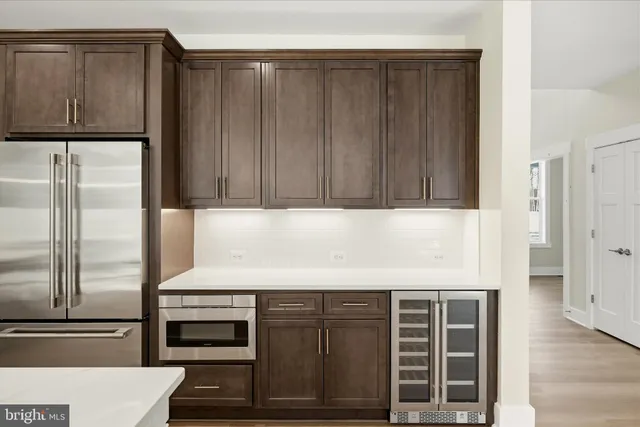 a kitchen with granite countertop wooden cabinets and stainless steel appliances