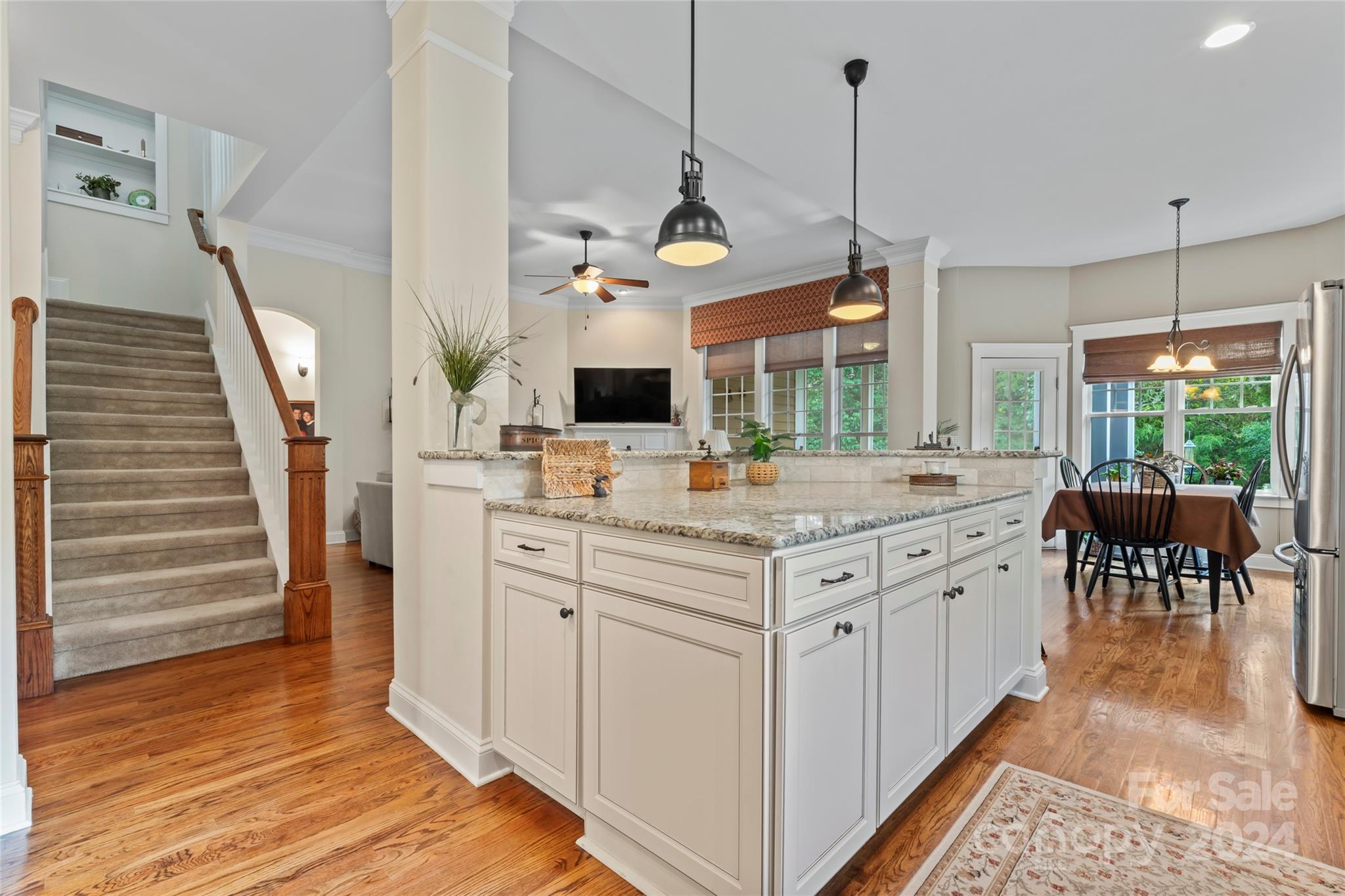 6059 Daphne Circle Fort Mill, SC 29708 - Photo 15 of 48 a kitchen with stainless steel appliances granite countertop a stove a sink and a wooden floors