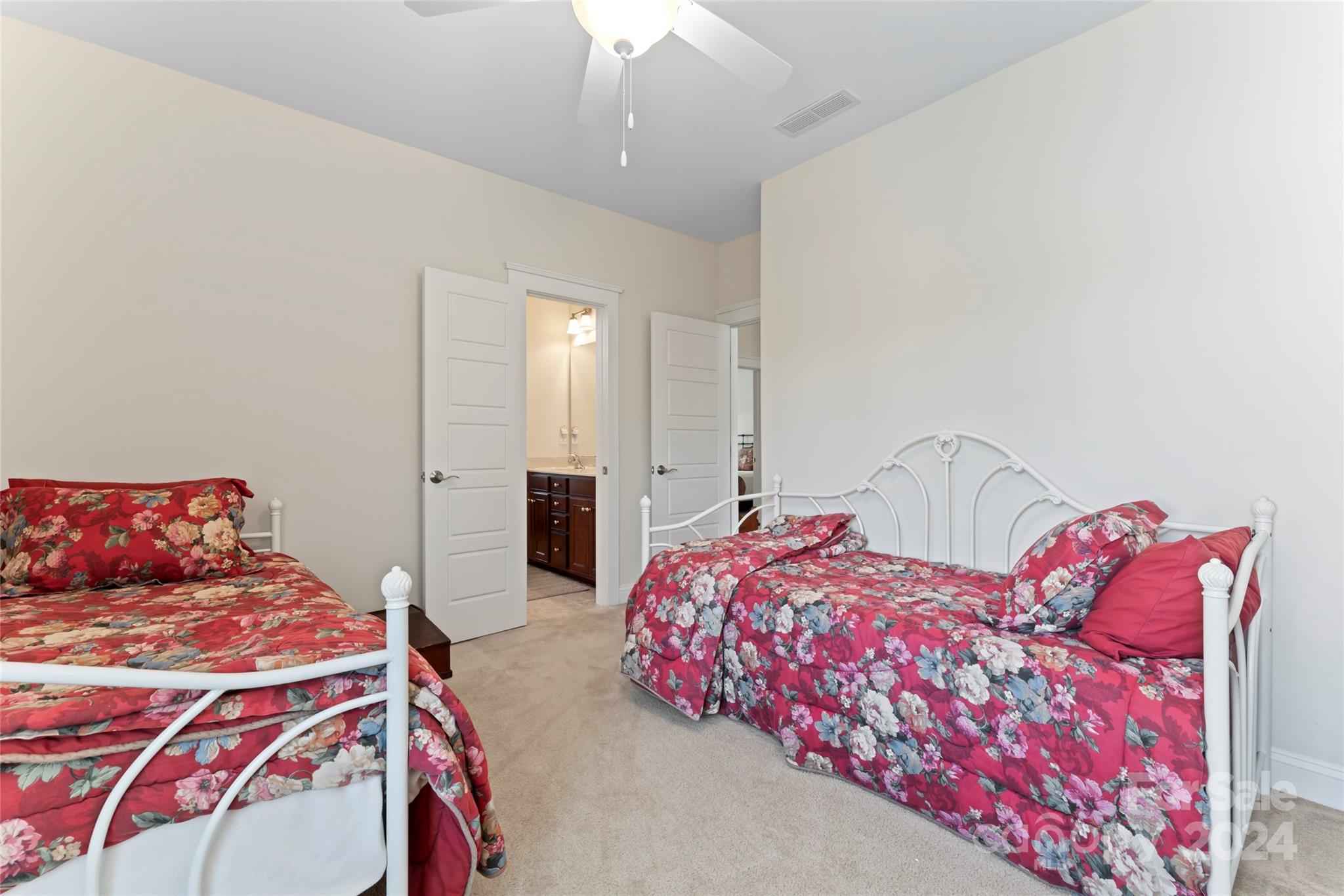 6059 Daphne Circle Fort Mill, SC 29708 - Photo 36 of 48 a bedroom with bed and a chandelier