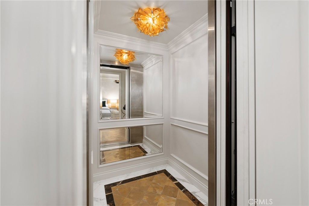 22 Deep Sea Newport Coast, CA 92657 - Photo 37 of 57 a view of a hallway with wooden floor and a mirror