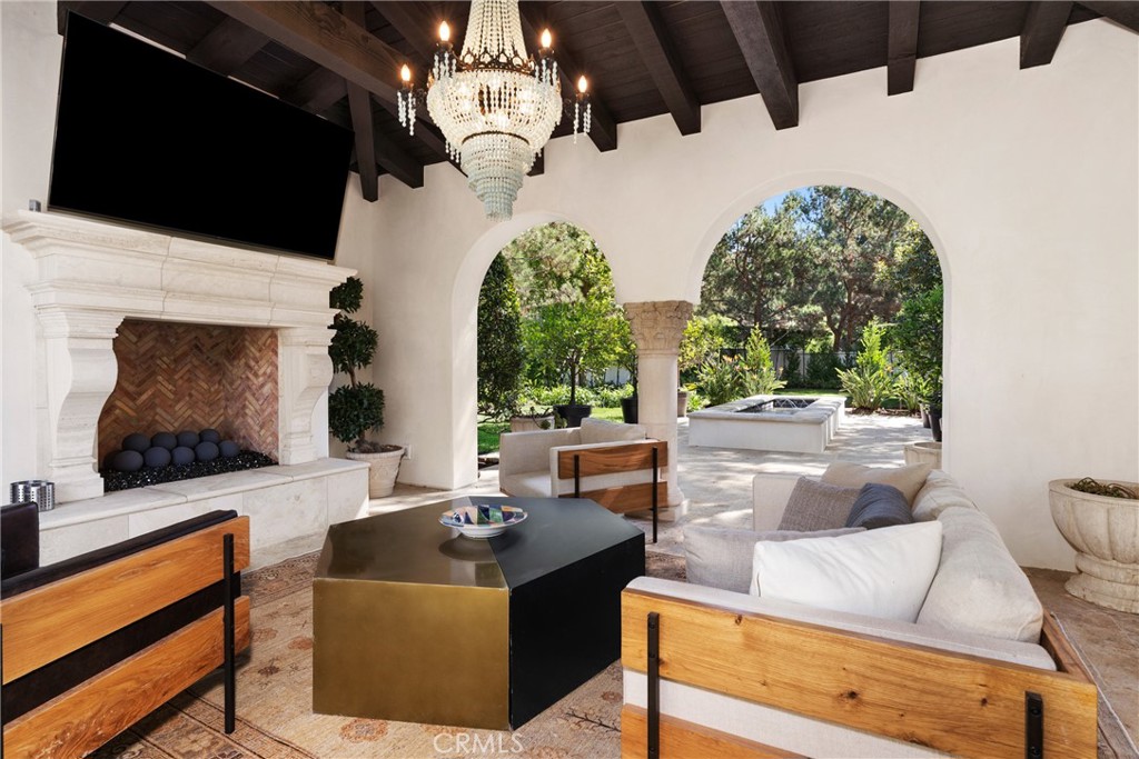 22 Deep Sea Newport Coast, CA 92657 - Photo 39 of 57 a living room with couches a flat screen tv and a fireplace