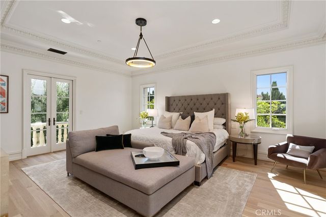 a living room with furniture a chandelier and a large window