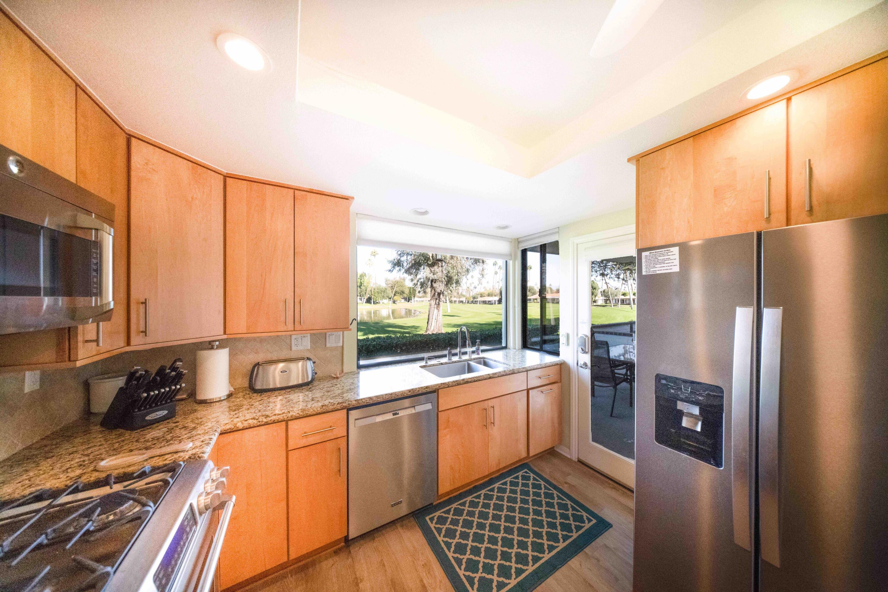 73 Marbella Drive Rancho Mirage, CA 92270 - Photo 14 of 43 a kitchen with stainless steel appliances a refrigerator sink and stove
