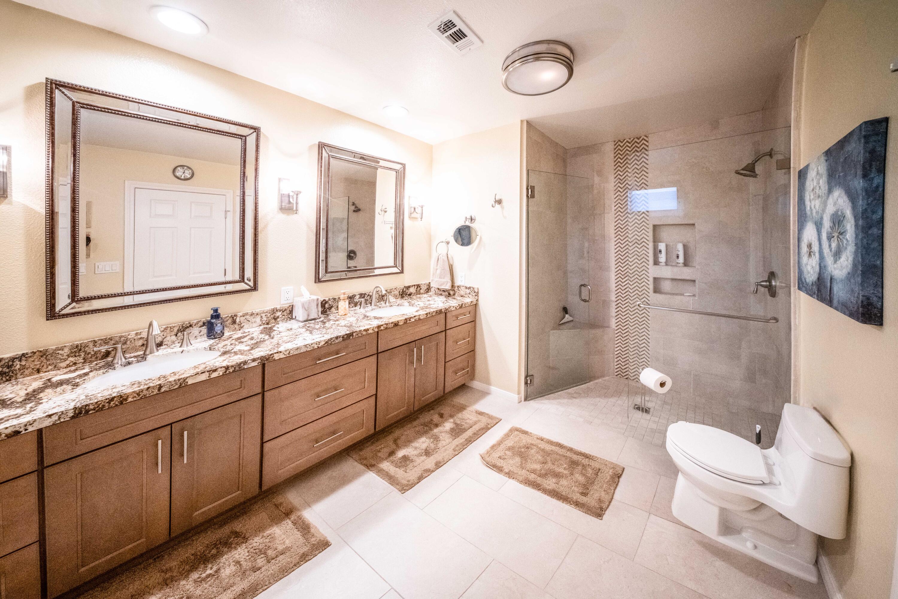 73 Marbella Drive Rancho Mirage, CA 92270 - Photo 17 of 43 a spacious bathroom with a double vanity sink toilet mirror and shower