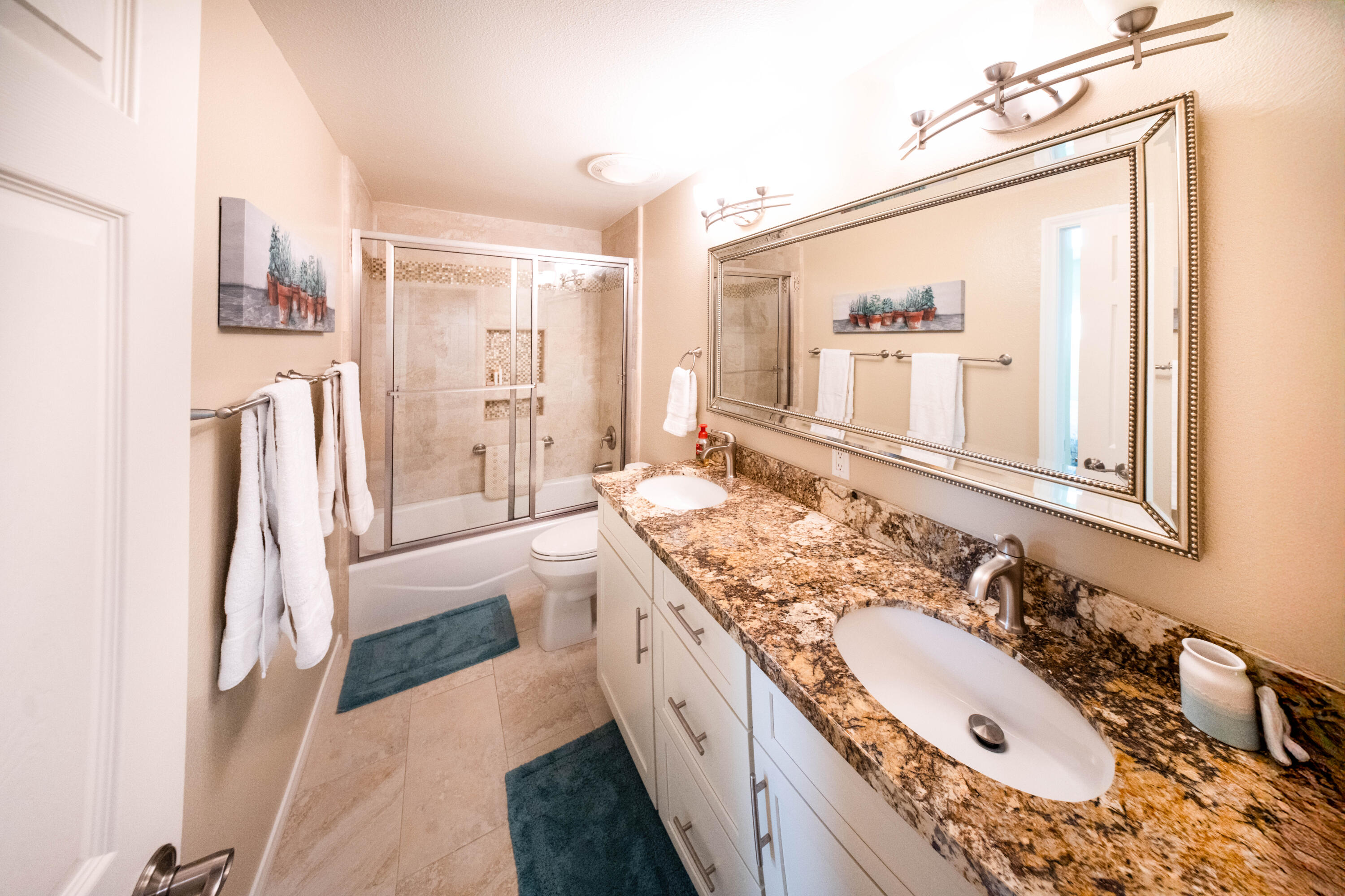 73 Marbella Drive Rancho Mirage, CA 92270 - Photo 21 of 43 a spacious bathroom with a double vanity sink a mirror and a bathtub